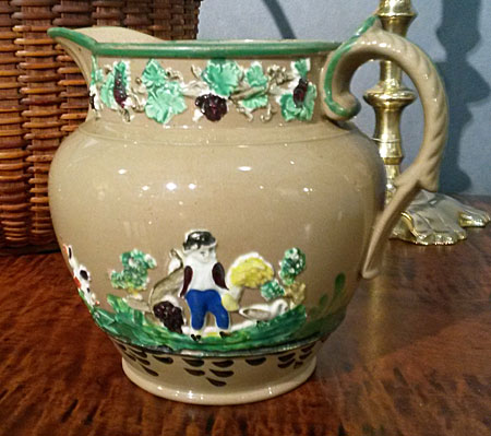 SOLD  Sprigged jug in merry colors.