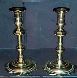 A pair of Queen Anne petal base candlesticks