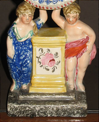SOLD   A CHARMING FIGURAL WATCH HOLDER
