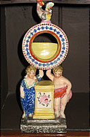 SOLD   A CHARMING FIGURAL WATCH HOLDER